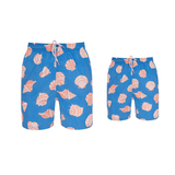 Designer matching swim shorts for father and son, blue with sea shells pattern